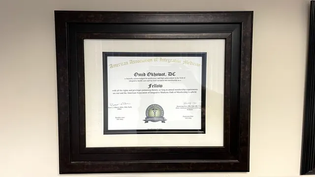 American Association of Integrative Medicine Fellow certificate on the office wall
