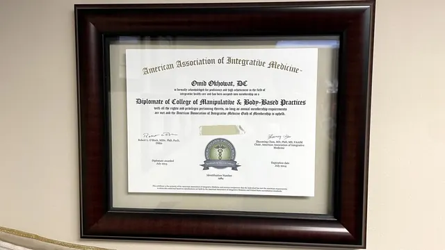 Diplomate of the College of Manipulative and Body Based Practices certificate on the office wall