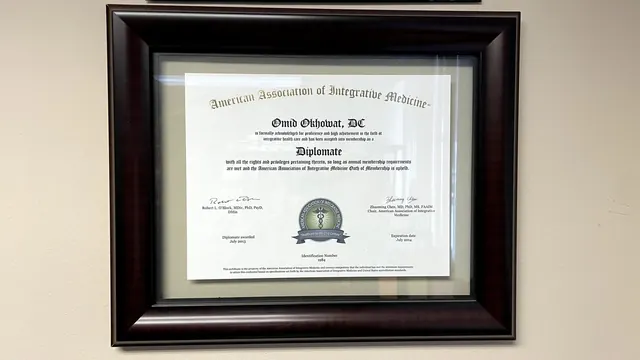 American Association of Integrative Medicine Diplomate certificate on the office wall