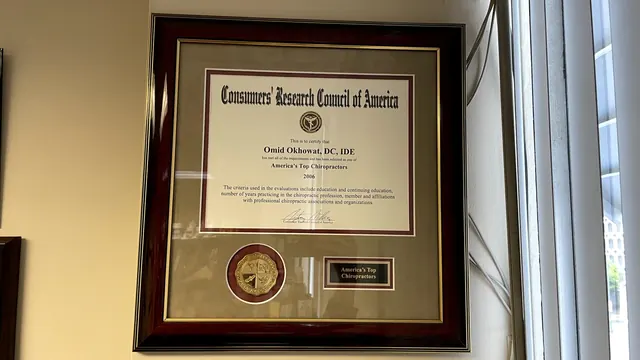 Framed Consumers' Research Council of America plaque beside a window in Dr. Okhowat's office
