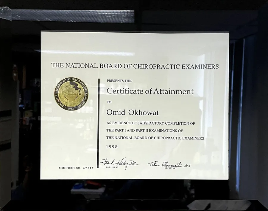 Framed Certificate of Attainment from the National Board of Chiropractic Examiners awarded to Omid Okhowat