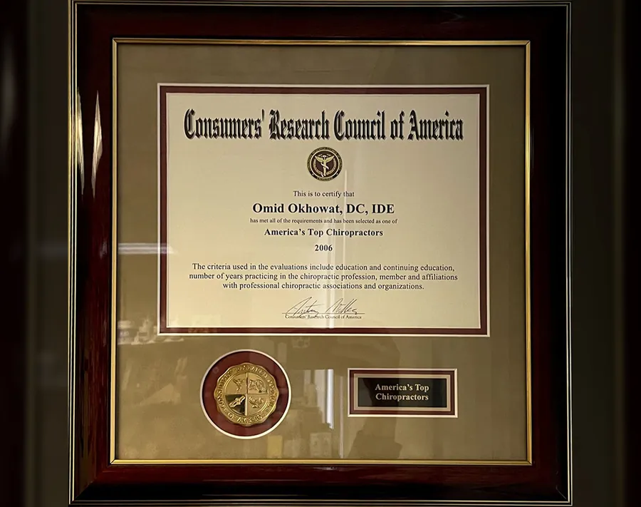 Framed Consumers' Research Council of America plaque naming Omid Okhowat among America's Top Chiropractors