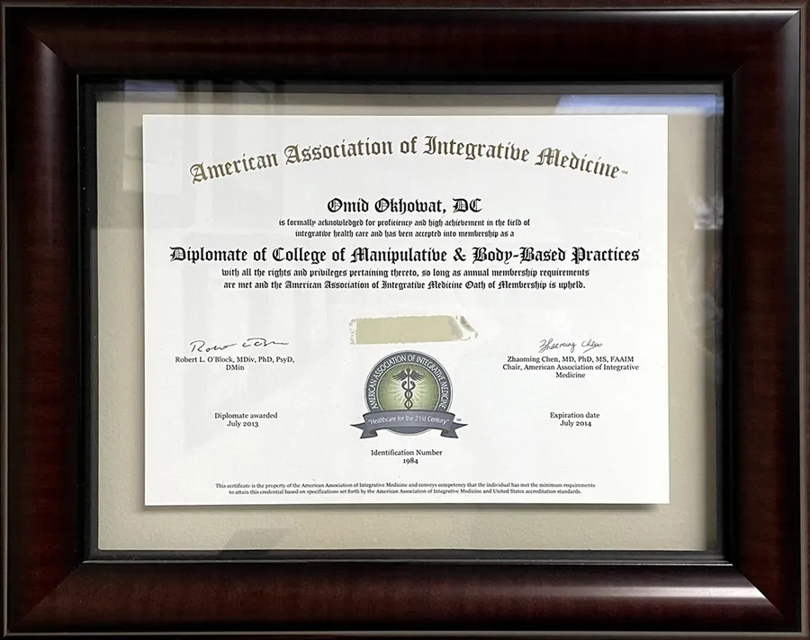 Framed certificate naming Omid Okhowat, DC a Diplomate of the College of Manipulative and Body Based Practices, American Association of Integrative Medicine